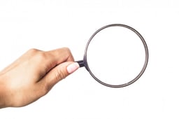 hand-holding-magnifying-glass-isolated-white