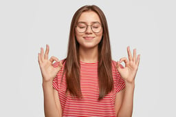 pleased-satisfied-young-female-model-makes-zero-gesture-wears-transparent-glasses-has-long-dark-hair