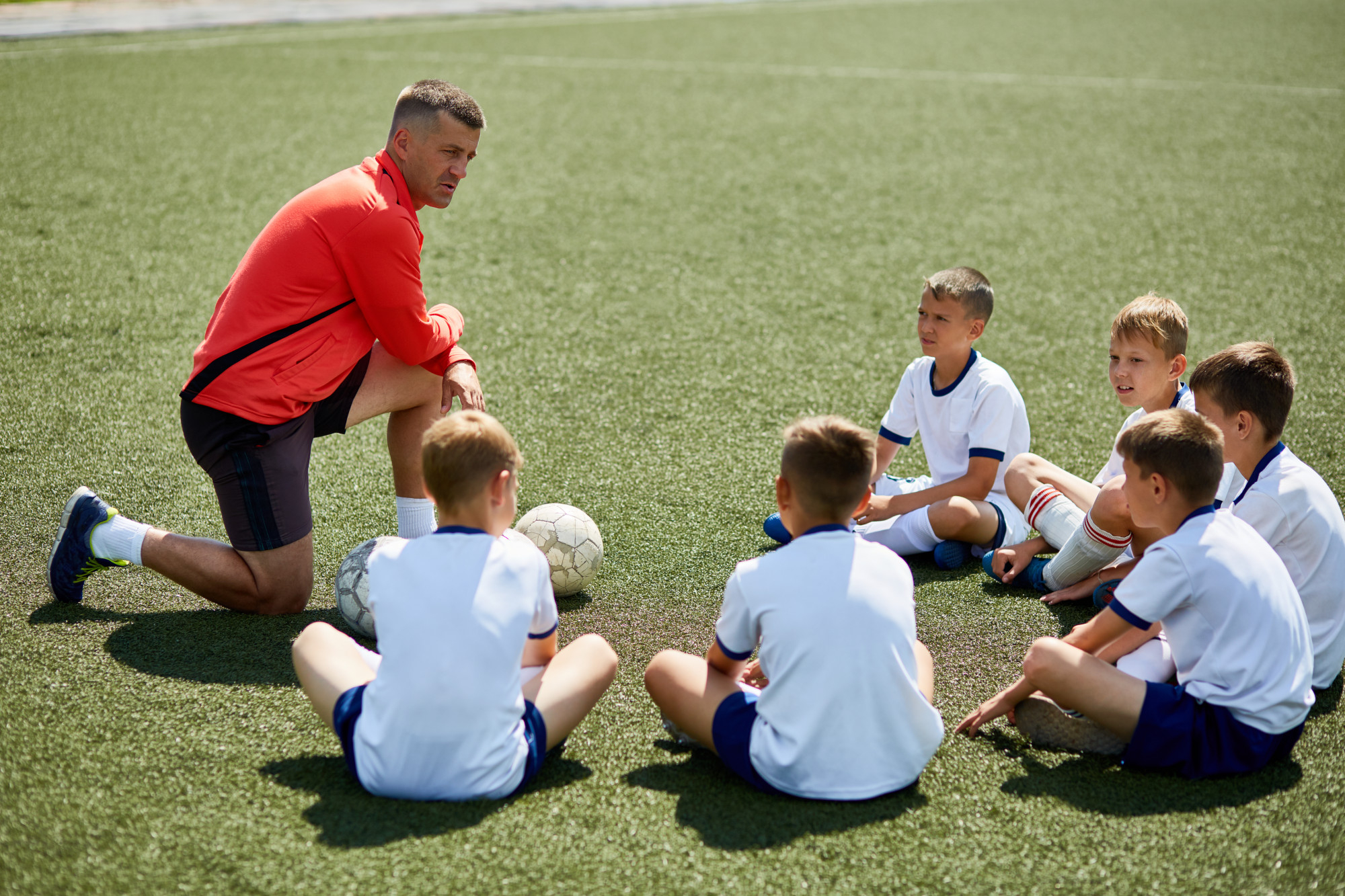 coach-instructing-junior-football-team